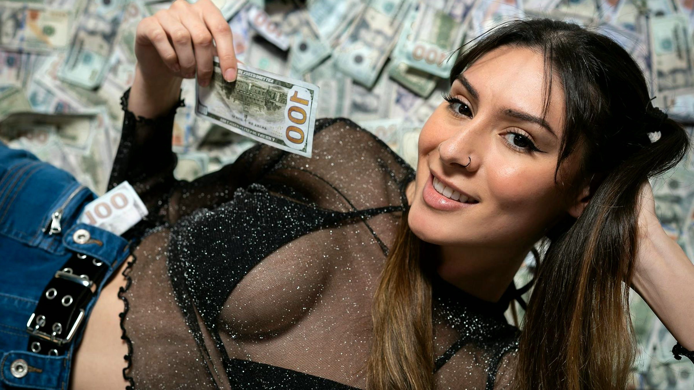 Glamorous adult creator posing with cash